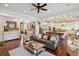 Living room with an open floor plan, fireplace, sofas, and an open flow to the kitchen at 4215 Ten Shillings Way, Ravenel, SC 29470