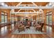 Beautiful lounge area with wood paneled walls, high ceilings, and a cozy fireplace at 4215 Ten Shillings Way, Ravenel, SC 29470
