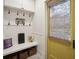 Cozy mudroom features a bench with storage, hooks, and a decorative yellow door at 4215 Ten Shillings Way, Ravenel, SC 29470