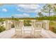 Enjoy the scenery from this quaint patio offering rocking chairs, a small table, and views of the natural landscape at 4215 Ten Shillings Way, Ravenel, SC 29470
