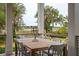 Covered porch with a wooden dining table provides a nice view of the marsh at 4215 Ten Shillings Way, Ravenel, SC 29470