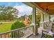 Scenic view from the porch featuring lush greenery, an American flag, and a tranquil atmosphere at 4215 Ten Shillings Way, Ravenel, SC 29470