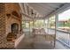 Cozy screened porch with a brick fireplace, comfortable seating, and scenic views at 4215 Ten Shillings Way, Ravenel, SC 29470