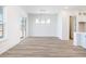 Bright dining room boasts wood floors, a modern light fixture and abundant natural light from the sliding glass doors at 432 Evening Glow Ln, Summerville, SC 29486