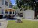 Inviting backyard patio area with a fire pit, patio furniture, hot tub, and well-maintained lawn at 482 Planters Trace Dr, Charleston, SC 29412