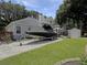 Spacious backyard featuring a boat on a trailer, lush lawn, patio with furniture, and storage at 482 Planters Trace Dr, Charleston, SC 29412