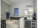 Inviting bathroom features a soaking tub, a vessel sink, and elegant gray tiling at 482 Planters Trace Dr, Charleston, SC 29412