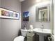 Half-bath showcasing updated fixtures, fresh paint, and modern decor at 482 Planters Trace Dr, Charleston, SC 29412