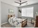 Comfortable bedroom with a wooden bed frame, quilt bedding, and ample natural light at 482 Planters Trace Dr, Charleston, SC 29412
