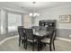 Elegant dining room featuring a modern chandelier, neutral walls, and a large window at 482 Planters Trace Dr, Charleston, SC 29412