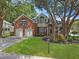 Charming two-story brick and siding home with a well-manicured lawn and mature trees at 482 Planters Trace Dr, Charleston, SC 29412