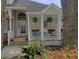 Cozy front porch with white railings and decorative plants, offering a welcoming entrance at 482 Planters Trace Dr, Charleston, SC 29412