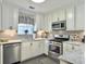 Spacious kitchen featuring stainless steel appliances, white cabinets, and updated countertops at 482 Planters Trace Dr, Charleston, SC 29412