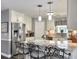 Kitchen boasts white cabinets, granite counters, and stainless steel appliances with a large center island at 482 Planters Trace Dr, Charleston, SC 29412