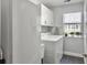 Bright laundry room featuring a washer, dryer, storage cabinets, and a window for natural light at 482 Planters Trace Dr, Charleston, SC 29412