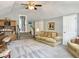 Upstairs living area with a couch, bookcase, and staircase, designed for relaxation and leisure at 482 Planters Trace Dr, Charleston, SC 29412