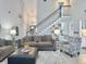 Bright living room with high ceilings, a staircase, and comfortable seating arrangements at 482 Planters Trace Dr, Charleston, SC 29412