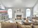 Inviting living room showcasing a fireplace, large windows, and comfortable seating at 482 Planters Trace Dr, Charleston, SC 29412