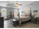 A bedroom with a tray ceiling, ceiling fan, and large windows that let in plenty of natural light at 482 Planters Trace Dr, Charleston, SC 29412