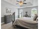 A bedroom with a tray ceiling, ceiling fan, and hardwood floors, creating a comfortable and inviting space at 482 Planters Trace Dr, Charleston, SC 29412