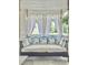 Inviting porch swing with white cushions and floral pillows, perfect for relaxing outdoors at 482 Planters Trace Dr, Charleston, SC 29412
