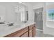 Bright bathroom featuring a double sink vanity and separate shower with glass door at 4823 Shady Tree Ln, Summerville, SC 29485