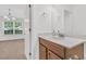 Bathroom sink features wood cabinet and view of bedroom, with natural light from window at 4823 Shady Tree Ln, Summerville, SC 29485
