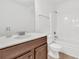 Bathroom features wood cabinet with white sink and countertop, toilet, and tiled shower and tub at 4823 Shady Tree Ln, Summerville, SC 29485