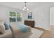 Bright bedroom features light hardwood floors, large window, and an elegant wooden dresser at 4823 Shady Tree Ln, Summerville, SC 29485