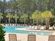 Relax by the community pool with palm trees, lounge chairs, and a serene atmosphere at 4823 Shady Tree Ln, Summerville, SC 29485