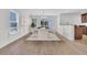 Bright dining area features modern decor, hardwood floors, wainscoting detail, and natural light, perfect for meals at 4823 Shady Tree Ln, Summerville, SC 29485