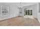 Bright dining room features wood flooring, large windows, and glass sliding doors at 4823 Shady Tree Ln, Summerville, SC 29485