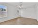 Bright empty room with wood floors, lots of natural light, and modern light fixture at 4823 Shady Tree Ln, Summerville, SC 29485