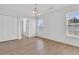 Bright empty room with wood floors, lots of natural light, and modern light fixture at 4823 Shady Tree Ln, Summerville, SC 29485