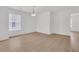 Bright empty room with wood floors, lots of natural light, and modern light fixture at 4823 Shady Tree Ln, Summerville, SC 29485