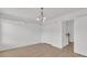 Bright empty room with wood floors, lots of natural light, and modern light fixture at 4823 Shady Tree Ln, Summerville, SC 29485