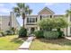 Charming two-story home with a well-manicured lawn and a beautiful palm tree in daytime at 4823 Shady Tree Ln, Summerville, SC 29485