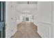 Bright foyer featuring hardwood floors, wainscoting detail, soaring ceilings, and elegant chandelier, creating an inviting entrance at 4823 Shady Tree Ln, Summerville, SC 29485