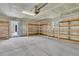 A spacious, unfinished garage featuring an abundance of shelving for storage at 4823 Shady Tree Ln, Summerville, SC 29485