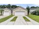 Spacious two-car garage and extended driveway with well-maintained landscaping at 4823 Shady Tree Ln, Summerville, SC 29485