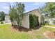 View of a detached garage, nestled among the shade trees and greenery at 4823 Shady Tree Ln, Summerville, SC 29485