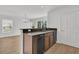 Kitchen view with stainless dishwasher, wood cabinets and sink with view to living room at 4823 Shady Tree Ln, Summerville, SC 29485