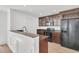 Open kitchen featuring dark wood cabinets, stainless steel appliances, and stone countertops at 4823 Shady Tree Ln, Summerville, SC 29485