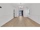 Expansive open living space with hardwood floors, wainscoting detail, and neutral color palette, offering versatility and elegance at 4823 Shady Tree Ln, Summerville, SC 29485