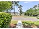 Neighborhood street view showcases well-maintained townhomes, verdant trees, and inviting community ambiance at 4823 Shady Tree Ln, Summerville, SC 29485