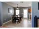 Dining room with a wooden table, seating for six, neutral paint, and view into the kitchen at 5094 Thornton Dr, Summerville, SC 29485