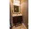 Traditional half bath with tile flooring, framed mirror and sink at 5094 Thornton Dr, Summerville, SC 29485