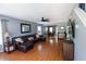 Cozy living room with hardwood floors, a leather sofa, ceiling fan, and access to the dining room at 5094 Thornton Dr, Summerville, SC 29485
