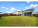 Large backyard with lush green grass and a view of neighboring homes at 512 Alderly Dr, Moncks Corner, SC 29461