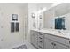 Well-lit bathroom with a double vanity, modern fixtures, and a view into the glass-enclosed shower at 512 Alderly Dr, Moncks Corner, SC 29461